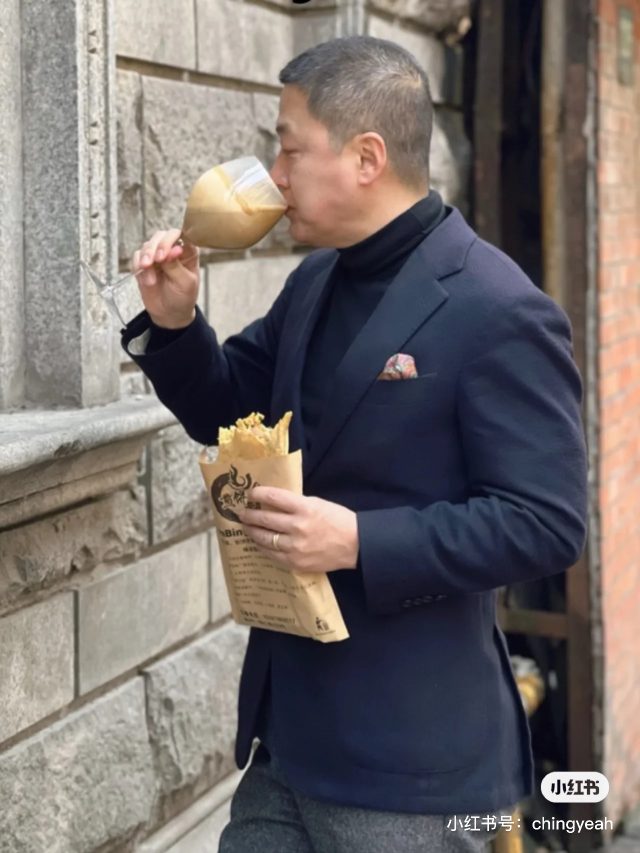 Man drinking coffee from a wine class on shanghai street